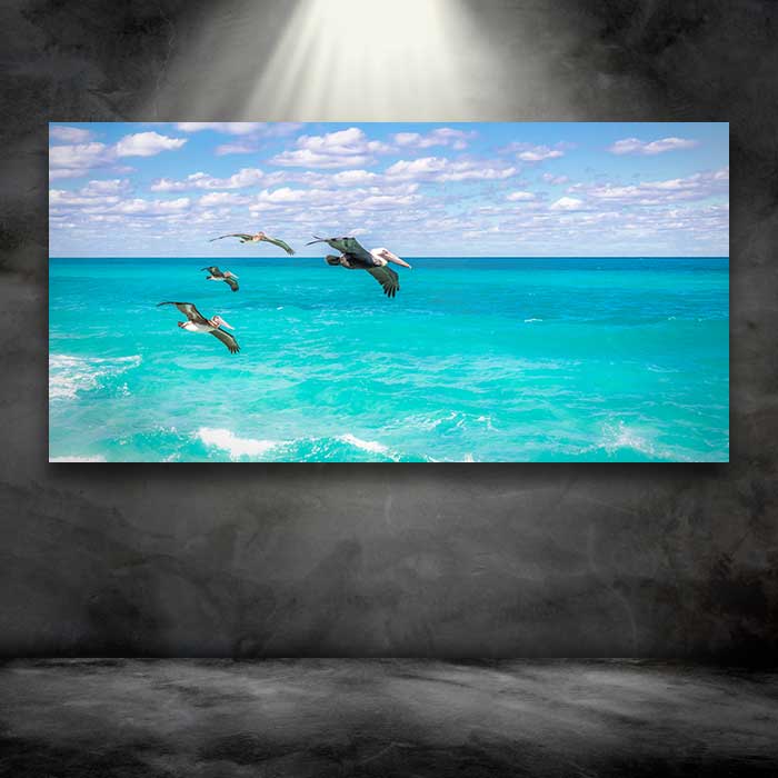 Pelicans in Flight Over the Ocean